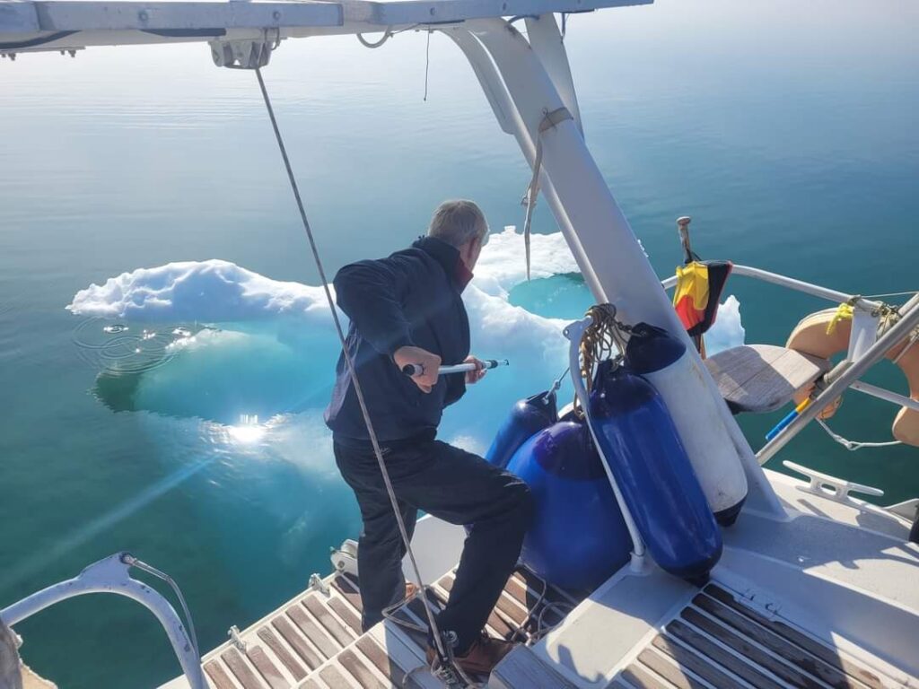 Graham pushing ice away from a yacht
